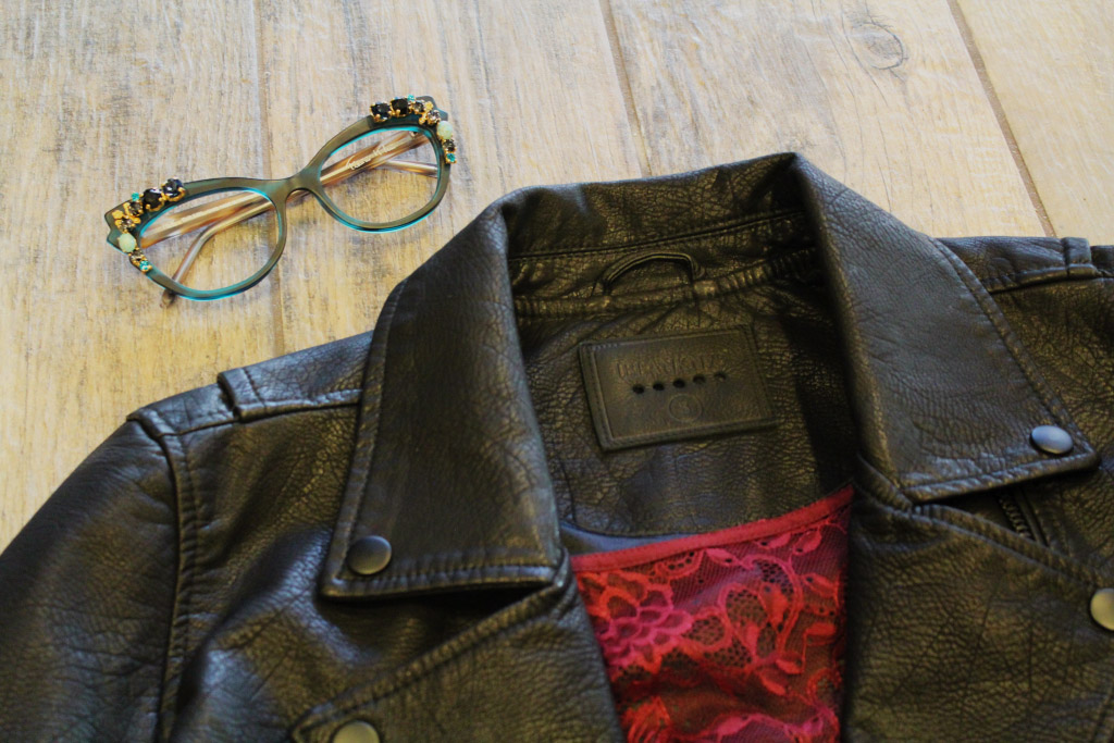 Black leather jacket and jeweled green frames